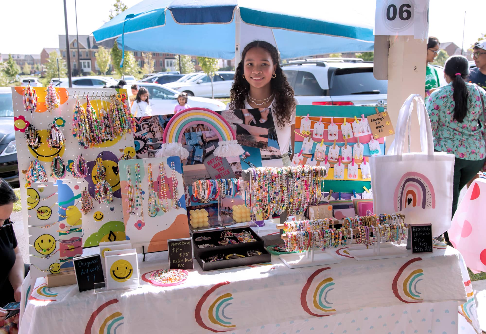 Young jewelry founder running her booth